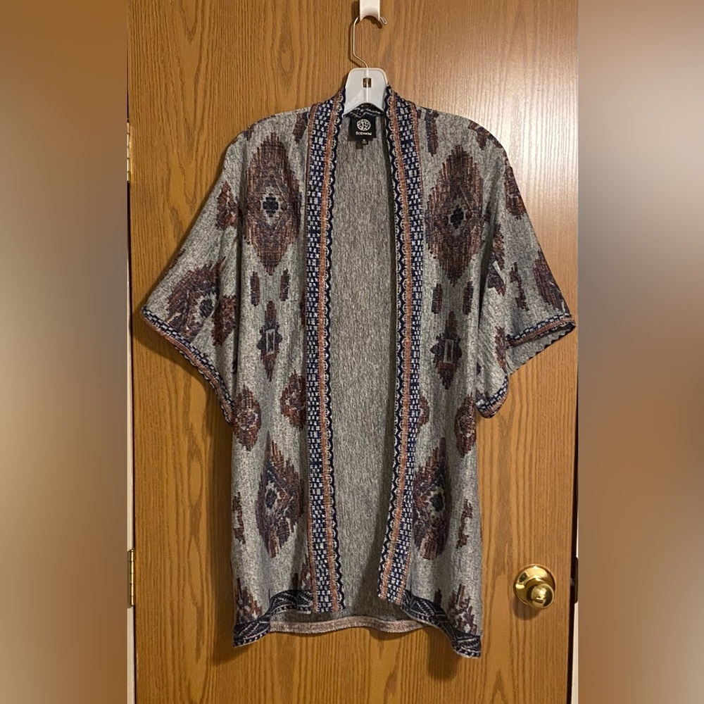 Wide sleeve cardigan with a western type print. Sits mid thigh